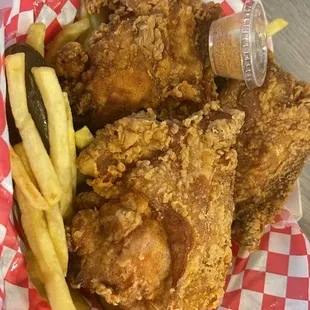 a basket of fried chicken and french fries