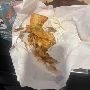 a half eaten sandwich and a bottle of water