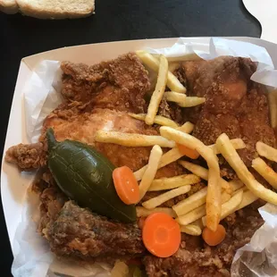 a plate of fried chicken and french fries
