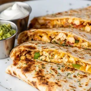 a plate of quesadillas with a side of guacamole