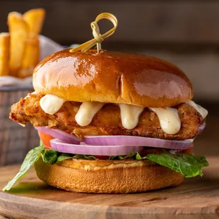 a chicken sandwich with cheese and onions