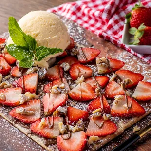 a dessert with strawberries and ice cream