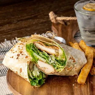 a chicken wrap with lettuce and french fries