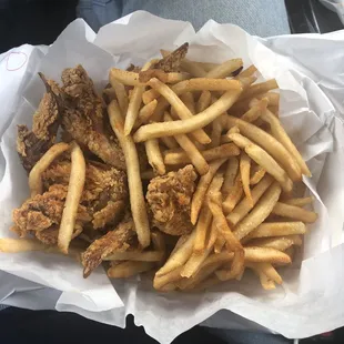 a basket of fried chicken and french fries