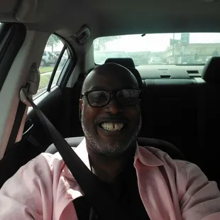 a man sitting in the back seat of a car