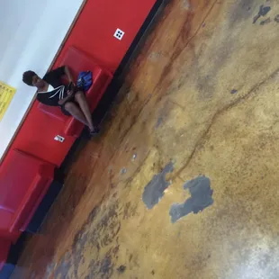 a woman sitting on a red bench