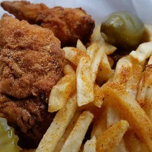 a basket of fries and pickles