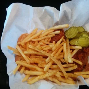 a basket of fries and a pickle