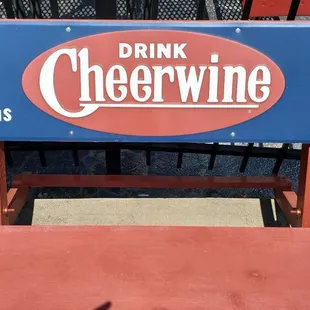 a blue and red sign that reads drink cheerwine it's good taste