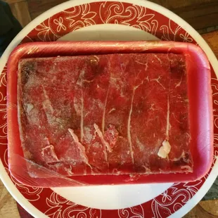 The meat with dark spot in an unnatural shape. This is from the big freezer in the market. They covered this with fresh slices on the top!!