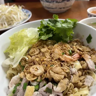 a bowl of noodles with meat and vegetables