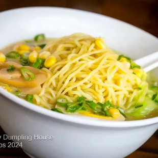 Chicken Ramen Miso broth with thick ramen noodles, grilled chicken, spinach, seasoned egg, scallions, chili oil, and chili powder.
