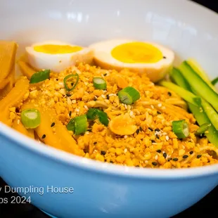 Tan Tan Noodle Ramen noodles with Tan Tan sauce infused with signature hot chili oil, scallion, crushed peanuts, sesame seeds, chili powder