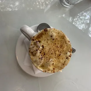 a cup of coffee on a white plate