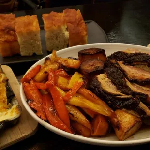 Family style Christmas dinner. Glazed porchetta sweet potato hoisin glaze. Roast pork mushroom jus glazed cider carrots and parsnip