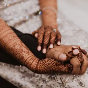 Such a lovely picture of the couple holding hands after their wedding! The dark ans rich henna stain accentuates the bride's entire look.