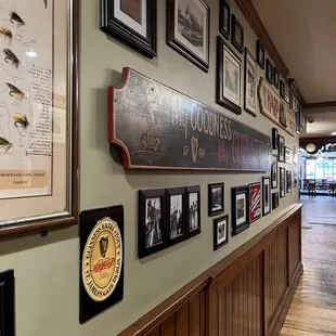 a long hallway lined with framed photographs