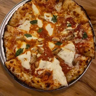 a pizza on a pan on a wooden table