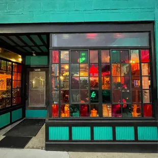 a storefront with a green brick wall