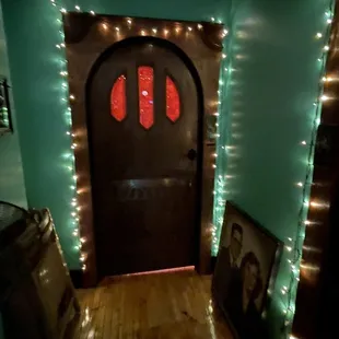 a hallway with christmas lights and a door