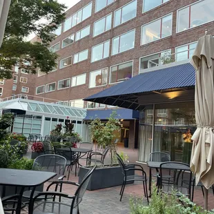 a patio with chairs and umbrellas