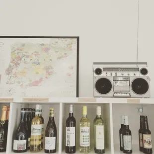a shelf of wine bottles and a radio