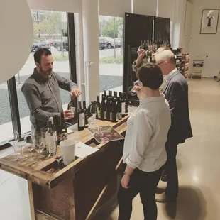 a man pouring a glass of wine