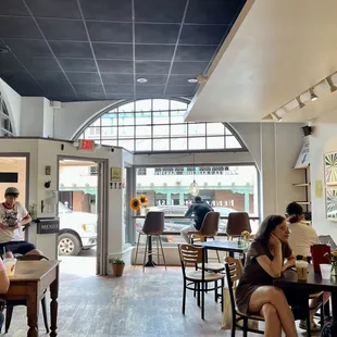 people sitting at tables in a restaurant