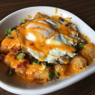 a bowl of food with a fried egg on top