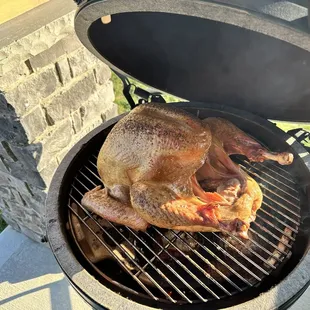 a roasting chicken on the grill