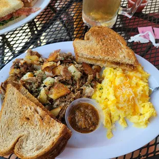 Carnitas hash with salsa, eggs scrambled w/ cheese toast