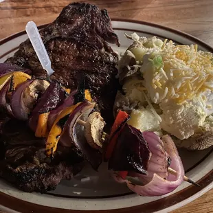 Strip steak with baked potato and veggie skewer