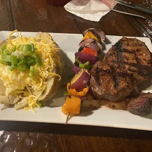 Filet mignon, baked potato, and veggie skewer