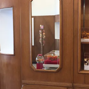 a wooden cabinet with a mirror