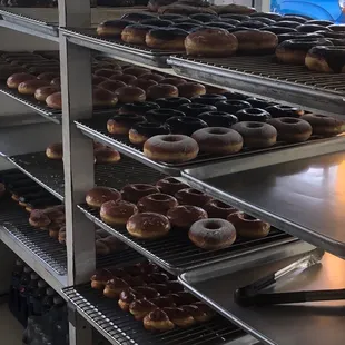 a variety of doughnuts on racks