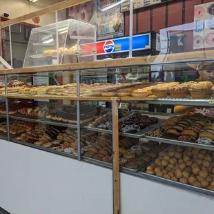 a variety of donuts in a display case