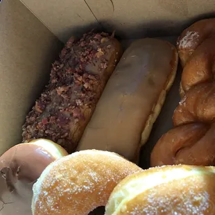 Maple bar with bacon, maple, variety of sugar donuts, custard with chocolate top