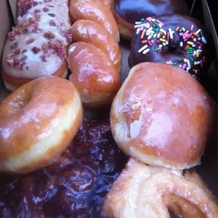 It&apos;s a box of donuts! Bacon maple, chocolate w/sprinkles, twist, apple fritter, boston creme, glaze, old fashioned...! :)