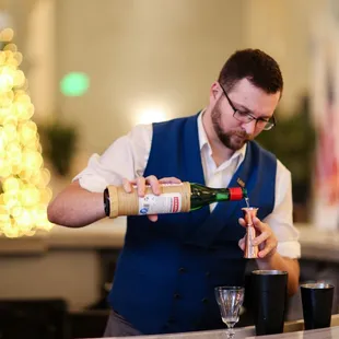 a bartender pouring a drink