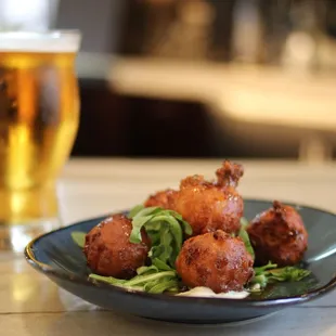 a plate of fried chicken and a glass of beer