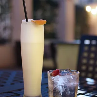 a glass of gin and a drink on a table