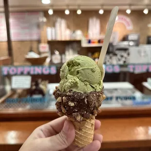 a hand holding an ice cream cone