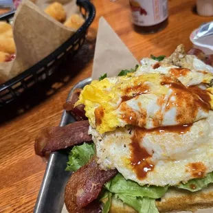 BLT with two fried eggs and a side of tater tots