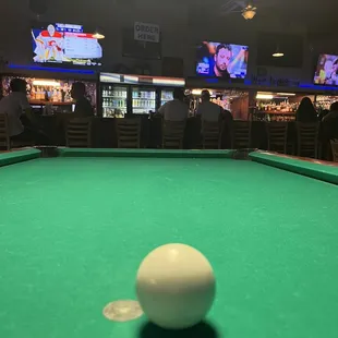 a pool table with a white ball on it