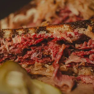 a roast beef sandwich with pickles
