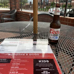 a beer and menu on a table