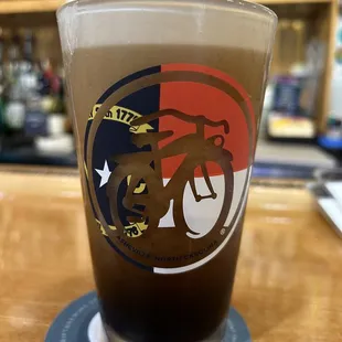 a pint glass on a coaster