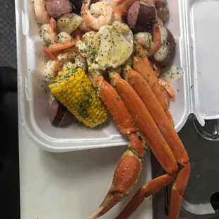 crab legs, corn, potatoes, and corn on the cob