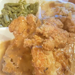 Smothered pork chops, mashed potatoes and green beans. Also had the peach cobbler. All was yummy