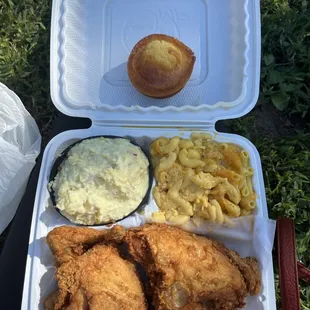 Fried half chicken with mac and cheese, potato salad, and cornbread